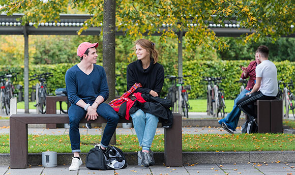 Students talking on the benches outside Ӱֱ, Edinburgh